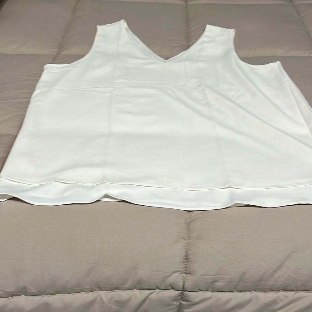 Sleeveless off white blouse.